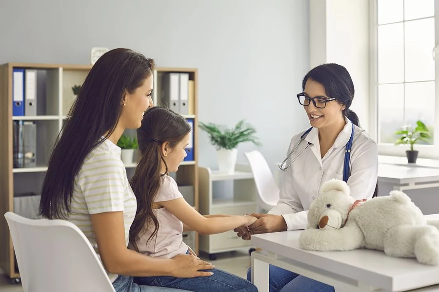 A doctor speaking with visitors in a medical facility